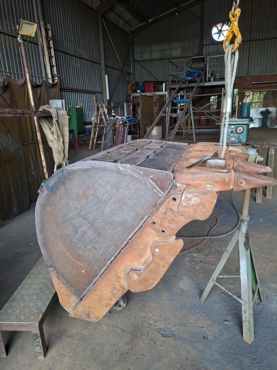 Excavator bucket being rebuilt